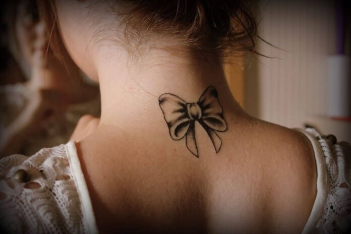 Awesome-Bow-Tattoo-On-Girl-Back-Neck